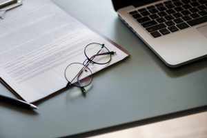 laptop with paperwork